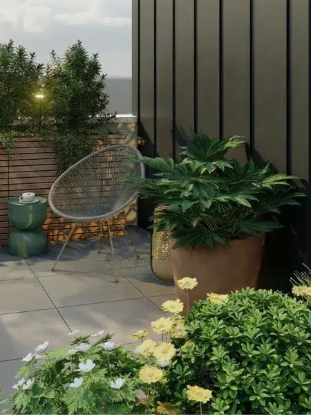 Coin repos sur une terrasse avec un fauteuil et des fleurs